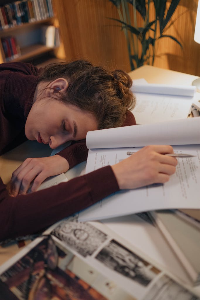 Young Woman Sleeping with Her Head on the Books