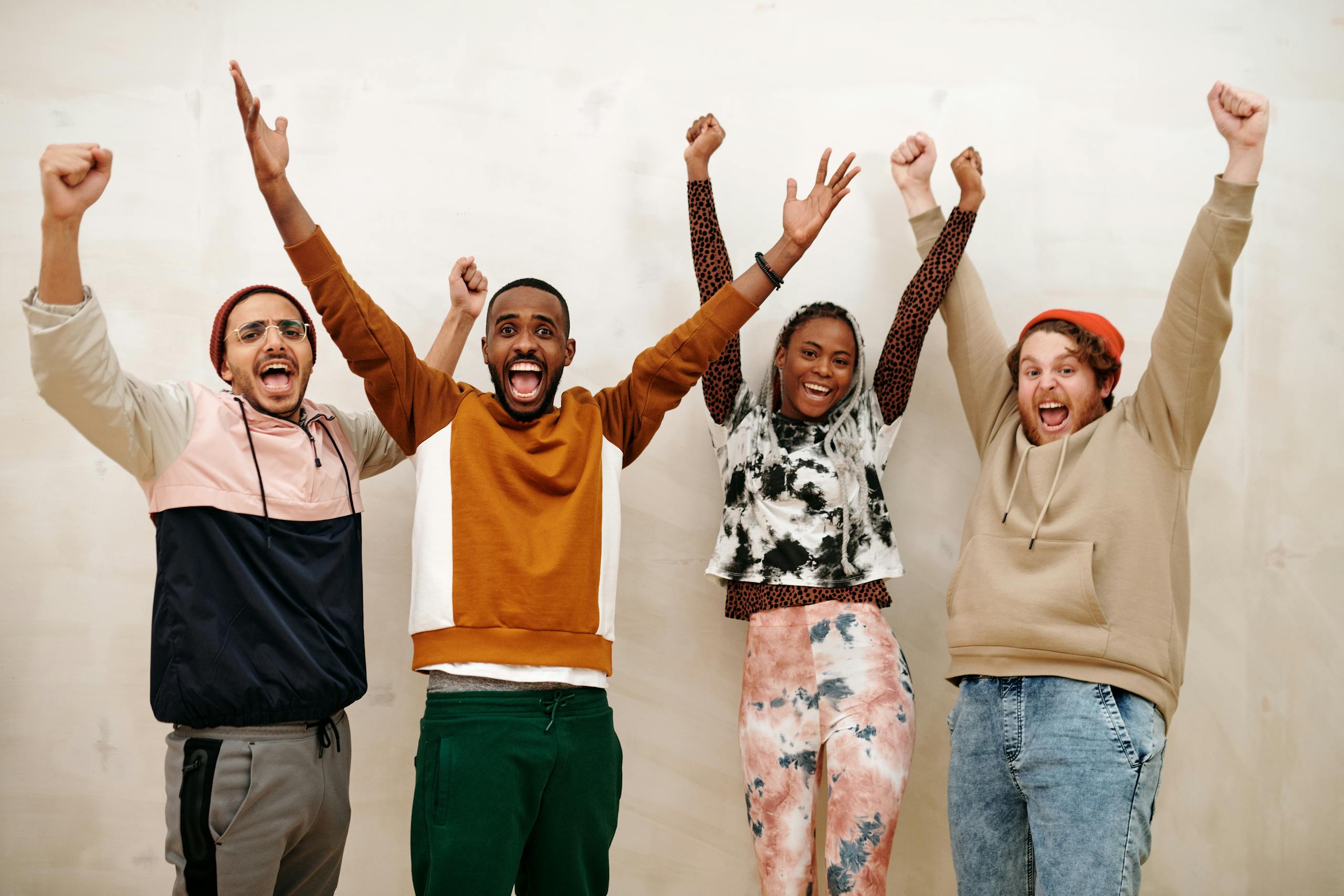 Multiracial People with Hands Raised